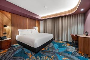 a hotel room with a bed and a desk at George Hotel Launceston in Launceston +51 photos