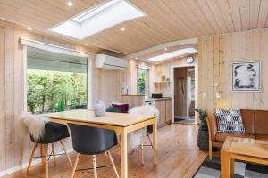 a kitchen and living room with a table and chairs at FY150-Middelfart-Vegavej-24 in Middelfart +27 photos