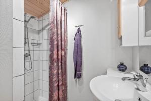 a bathroom with a sink and a shower curtain at FY150-Middelfart-Vegavej-24 in Middelfart