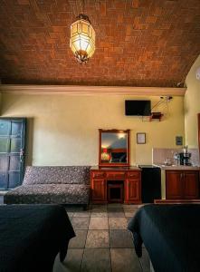 a living room with a couch and a mirror at Álamos Bonito Resort in Álamos