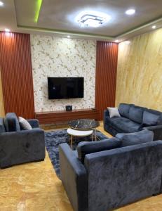 a living room with couches and a flat screen tv at Two bedroom living room single courtyard villa 