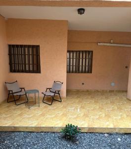 two chairs and a table in an empty room at Two bedroom living room single courtyard villa  +3 photos