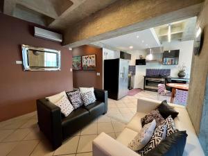 a living room with a couch and a kitchen at Avila apartment in Caracas