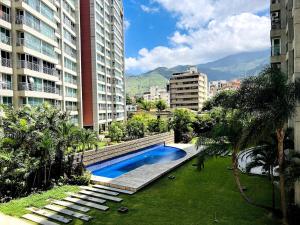 a swimming pool in the middle of a city with buildings at Avila apartment in Caracas