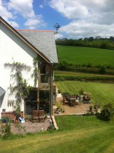 a view of a house with a patio at East Dunster Deer Farm B&B in Tiverton
