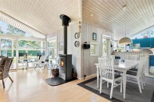 a kitchen and dining room with a wood stove at FY237-Otterup-Vestparken-6 in Otterup