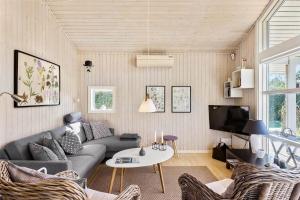 a living room with a couch and a tv at FY237-Otterup-Vestparken-6 in Otterup