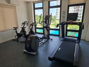 a gym with three treadmills and exercise bikes at EuroAsian Royal Oceancrest Mactan in Sudtungan