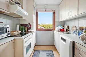 a kitchen with white appliances and a window at FY267-Faaborg-Horsehoved-37 in Fåborg