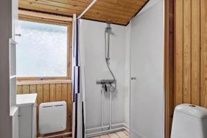 a bathroom with a shower and a toilet at HA306-Asaa-Strandgardsvej-68 in Aså +12 photos