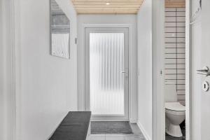 Un baño blanco con inodoro y ventana. en LF10202-Thyholm-Markvejen-2, en Thyholm 19 fotos más