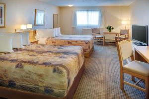 מיטה או מיטות בחדר ב-Nova Inn Kindersley