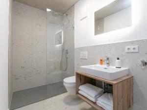 a bathroom with a sink and a toilet at Hopfgarten Alpin Living Top 1 und 2 in Hopfgarten im Brixental +32 photos