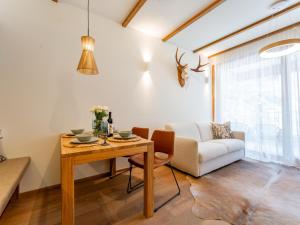 a living room with a table and a couch at Sonnenalpe Nassfeld Bergblume in Sonnenalpe Nassfeld +24 photos