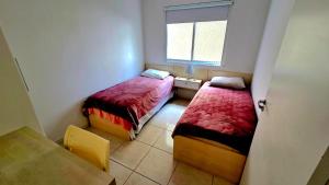 En eller flere senge i et værelse på Jardim Cristal