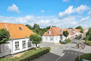 a person riding a bike down a street with houses at FY245-Assens-Ramsherred-25 in Assens