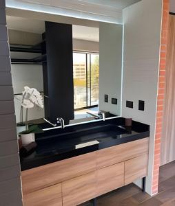 a bathroom with a black sink and a mirror at TORRE ARCARTI Internet alta velocidad y estacionamiento in San Baltasar +63 photos