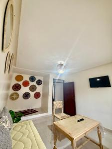 a living room with a table and some plates on the wall at Family house in Ourika