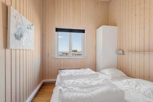 a bedroom with two beds and a window at FY300-Faaborg-Mosegarden-43 in Bogentved