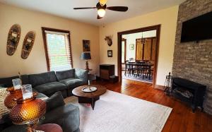 a living room with a couch and a fireplace at The Franklin House in Franklin