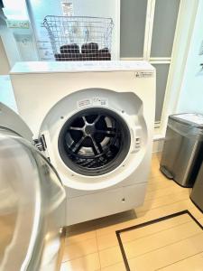 a washing machine with a basket on top of it at Capital Shimbashi 101, Studio in Tokyo