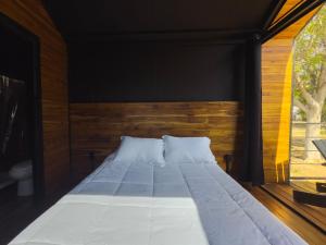 a large bed in a room with a large window at Amazing cabin in Samalayuca in Samalayuca +6 photos