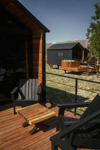 a deck with a table and chairs on a house at Amazing cabin in Samalayuca in Samalayuca