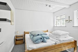 a bedroom with two beds with blue pillows at FY283-Broby-Sandholtvej-45 in Sandholts-Lyndelse