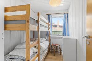 a bunk bed in a room with a ladder at FY316-Hesselager-Syrenvej-8 in Hesselager
