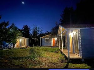 a tiny house with a porch at night at Hualqui Estancia Aliwen in Hualqui