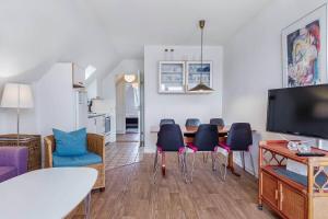 a living room with a dining room table and chairs at FY330-Kerteminde-Klintevej-45-lej-22-1-sal in Kerteminde