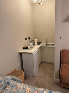 a small kitchen with a sink and a counter top at Double Deluxe Centre Apartment- Free Parking - Self Check-In - Cctv in Huddersfield