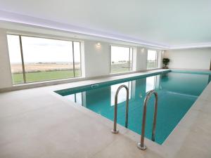 a swimming pool in a house with windows at Glebe Cottage in Alnwick