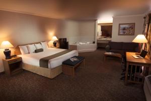 a hotel room with a bed and a couch at The Redwood Riverwalk, a boutique hotel in Fortuna