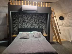 a bed with pillows on it in a room at Glamping Agro Marzenie in Krajno Pierwsze