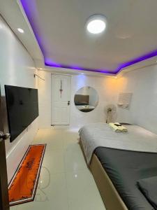TacondoにあるRQ Pool Villa, Angeles Cityのベッドとテレビのある小さな部屋 +56枚の写真