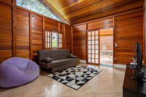 a living room with a couch and a checkered floor at Chalé Recanto da Paz in Itu