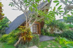 a house with a wooden deck in front of it at Cemara Hills Uluwatu, The Reserve - Cottages & Villas in Uluwatu