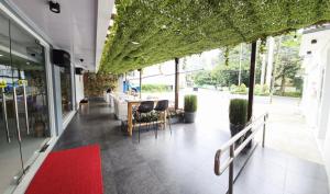 a restaurant with a red carpet on the floor and plants at Leribi Suites and Restaurant in Ulot