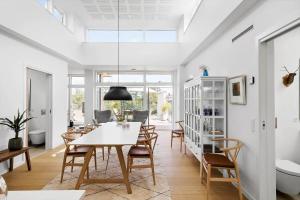 a dining room with a table and chairs at 5607-Svaneke-Mollebakken-8-P in Svaneke