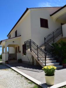 a white house with stairs and a stair case at Guesthouse Marko in Poreč