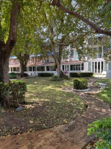 a large building with trees in front of it at Villas de Playa II in Jayuya
