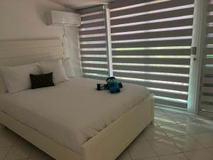 a bedroom with a bed with a backpack on it at Villas de Playa II in Jayuya +5 photos
