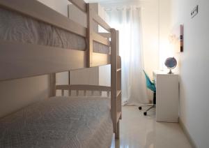a bedroom with a bunk bed and a desk at Kisa Apartments de Manresa in Manresa