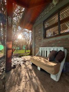 a bed sitting on the back of a porch at La Perla in El Bolsón