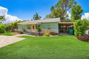 a green house with a green yard at Karen's Sea-Foam Oasis in Bonita Springs