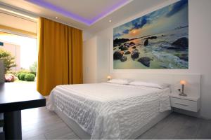 a bedroom with a bed and a painting on the wall at Villa Principessa Podstrana in Podstrana +94 photos