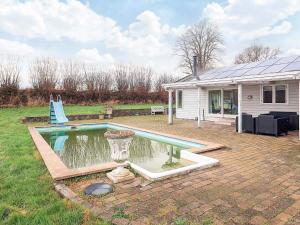 a house with a swimming pool in the yard at 10-Person Home in Rødvig Stevns in Lund