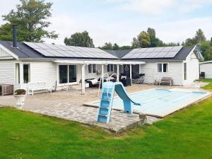 a house with a pool and a slide in the yard at 10-Person Home in Rødvig Stevns in Lund