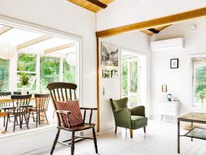 a living room with rocking chairs and a table at 6 person holiday home in Nykøbing Sj-By Traum in Nykøbing Sjælland